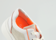 Ladies' sports shoes in white and orange colours Thumb