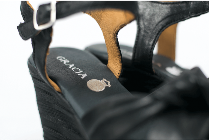 Black ladies' sandals with a wedge-shaped heel