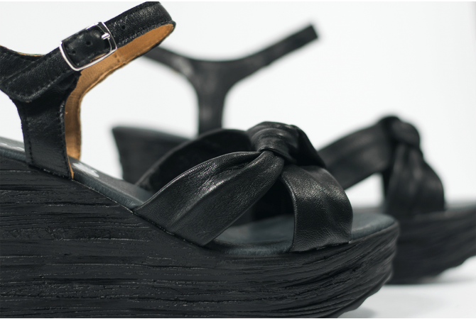 Black ladies' sandals with a wedge-shaped heel